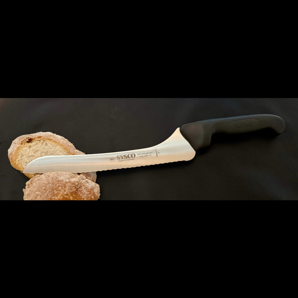 Offset bread knife with serrated blade resting on crusty bread