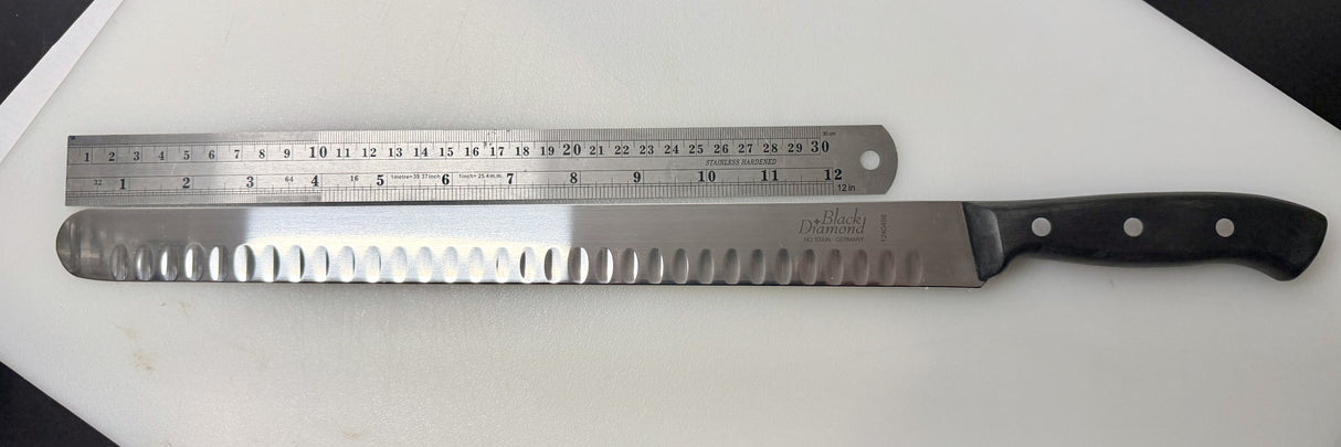 Serrated carving slicer knife with steel blade, black handle, and ruler-style markings