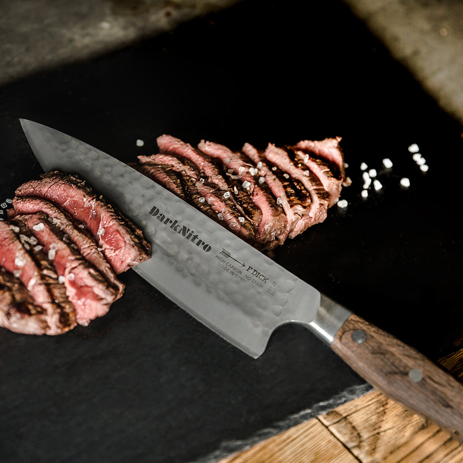 DarkNitro chef knife with textured gray blade and oak wood handle, angled