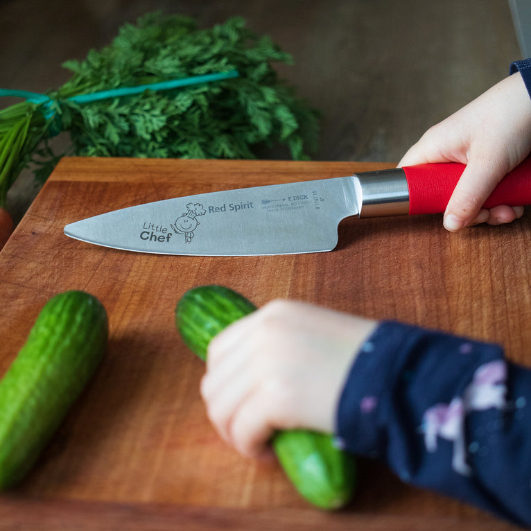 Red-handled chef's knife with Little Chef design on the blade