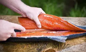 F.Dick ErgoGrip filleting knife cutting salmon, blue flex blade in use