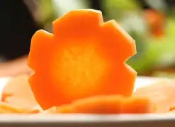 F. DICK channel knife carving an orange fruit wedge