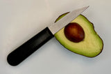 3-inch paring knife with textured black handle next to halved avocado
