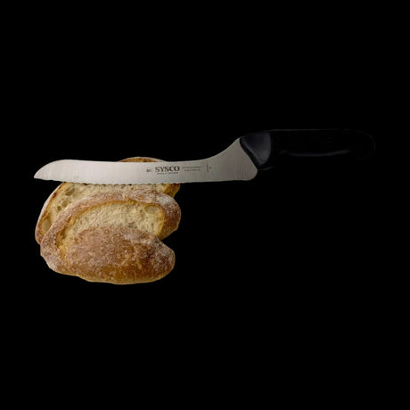 Offset serrated bread knife with dark handle next to sliced bread