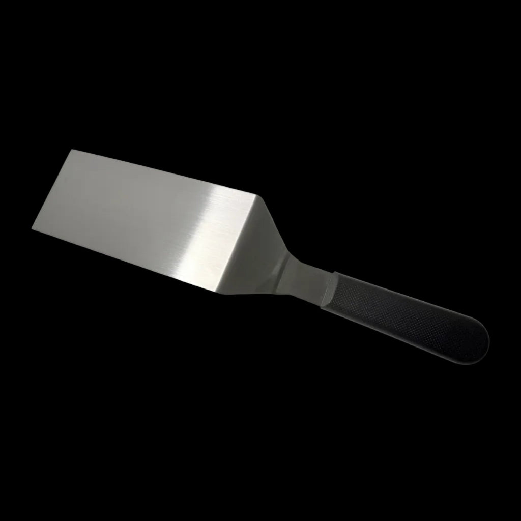 Hamburger turner with wide stainless steel blade and dark textured handle