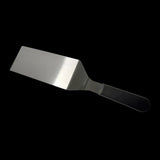 Hamburger turner with wide stainless steel blade and dark textured handle