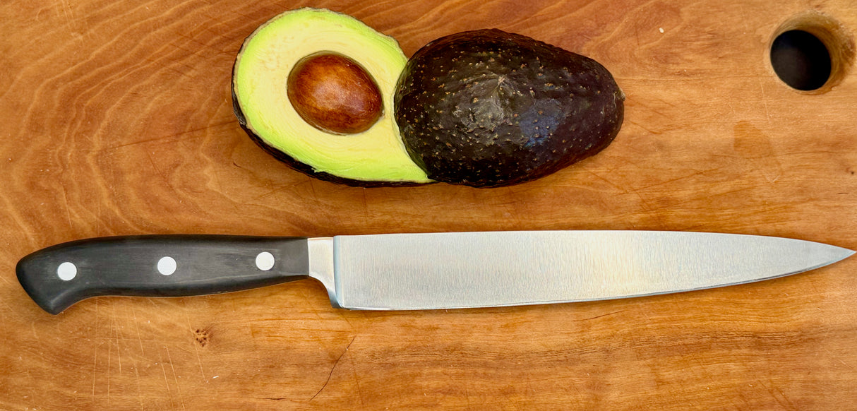 F.Dick Black Diamond slicer knife on wooden board; black handle with three rivets, steel