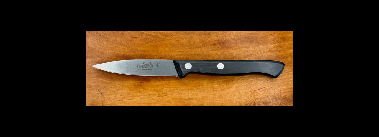 Paring knife with black handle and two white rivets, straight edged steel blade
