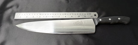 Chef’s knife with stainless blade, black riveted handle, back ruler-style markings