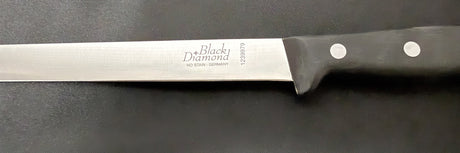 Carving knife close-up: steel blade with 'Black Diamond' text, dark handle