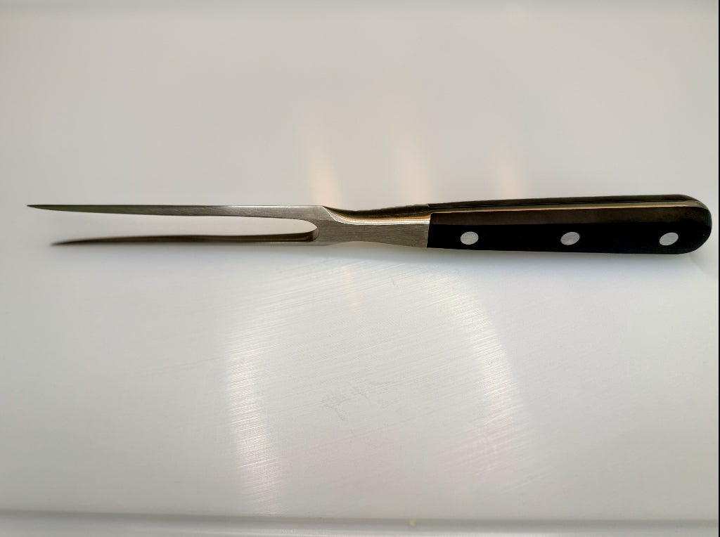 Forged meat fork with black handle and three rivets, two pointed tines