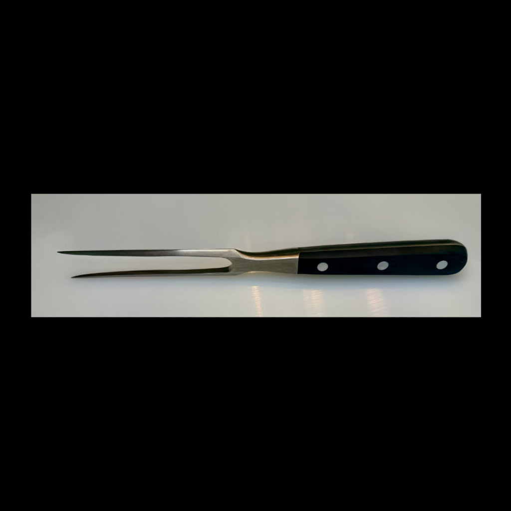 Stainless steel carving fork with black handle on a white background