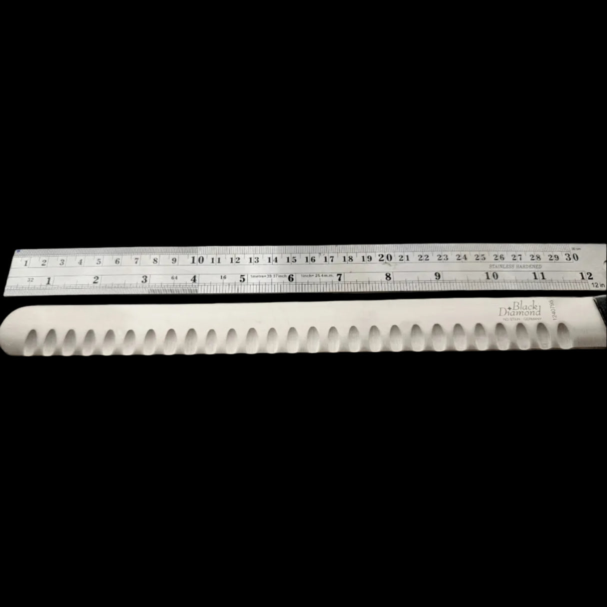 Knife blade with a ruler showing measurements on a white background
