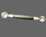 Double-ended stainless steel melon baller with black handle and two scoops