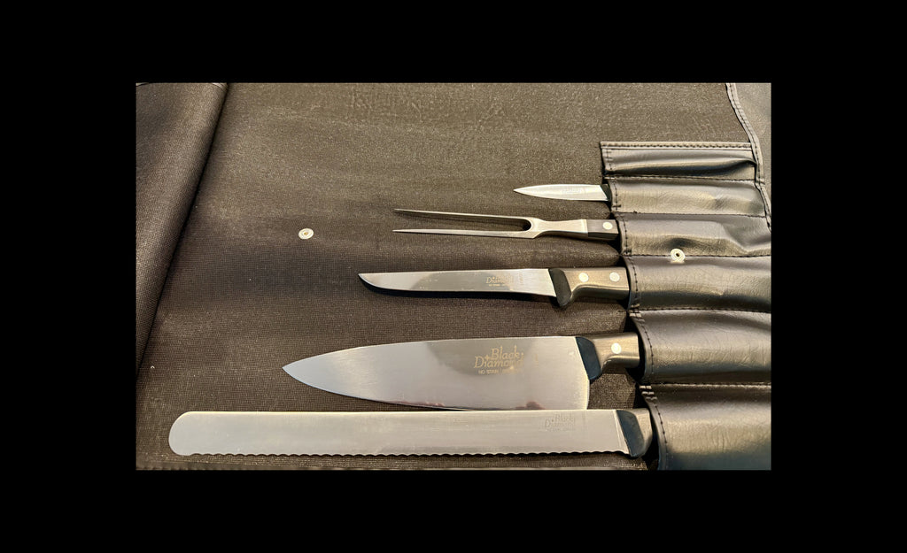 Set of knives and a fork on a leather case