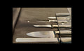 Set of knives and a fork on a leather case