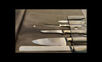 Set of knives and a fork on a leather case