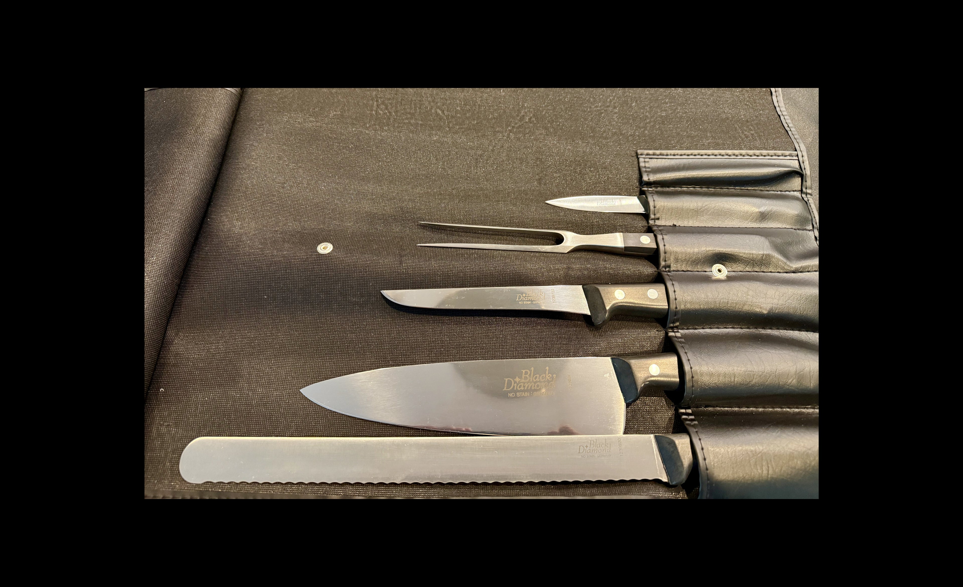 Set of knives and a fork on a leather case