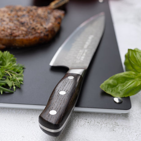 Chef knife with DarkNitro textured blade and dark oak handle with three rivets