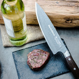Chef knife with DarkNitro hammered blade and oak handle with three rivets