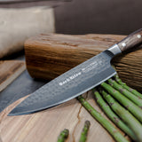 DarkNitro chef knife with oak handle and textured blade, angled on a cutting board