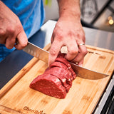 10-inch butcher knife slicing beef on a wooden cutting board