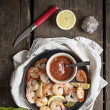 F.Dick Red Spirit tourne knife with red handle beside shrimp and sauce bowl