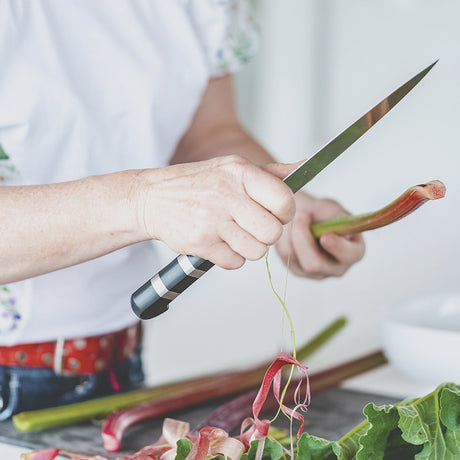 Flex filleting knife with black striped handle, held in hand