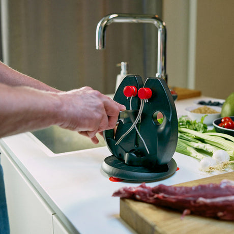 Green and black knife sharpener stand with red knobs and steel guide arms