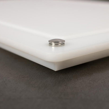White cutting board corner with raised stainless grommet