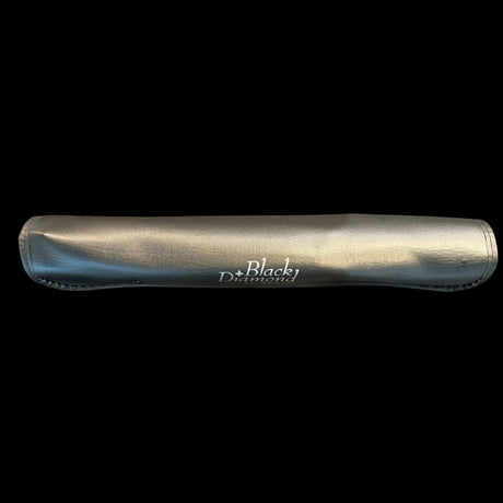 Black-handled knife in protective sleeve, stainless blade and branding visible