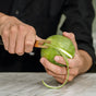 F. DICK channel knife with yellow blade trimming green fruit