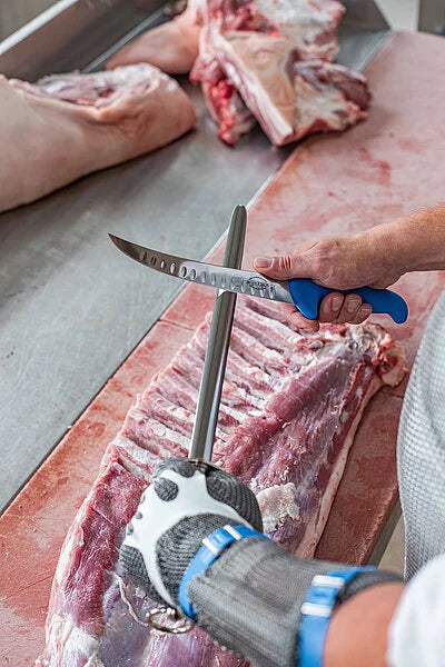 12-inch sharpening steel with blue handle, held over meat for polishing