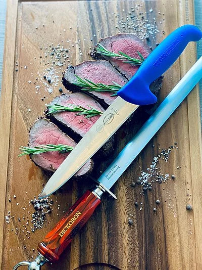 DICKORON knife with red handle and silver blade chopping cooked meat