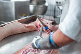 DICKORON knife in use with silver blade and red handle near food prep