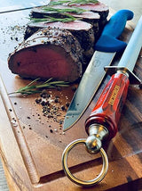 DICKORON carving knife with red handle and silver blade on a wooden cutting board