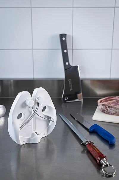 DICKORON knife with black-and-red handle and silver blade on kitchen counter