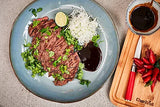 F.Dick Red Spirit paring knife with red handle beside a plated meal and lime