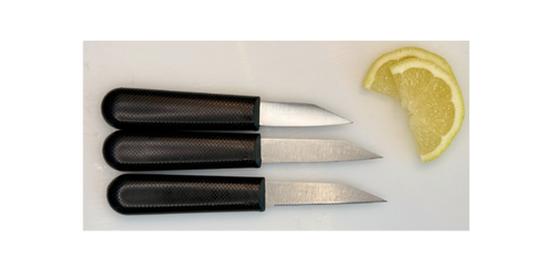 Three small knives with black handles on a white surface next to a lemon wedge.