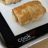Half-size silicone baking mat CookUP in tray with baked bread pieces