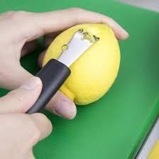 Black channel knife zester with silver blade, shown on a lemon